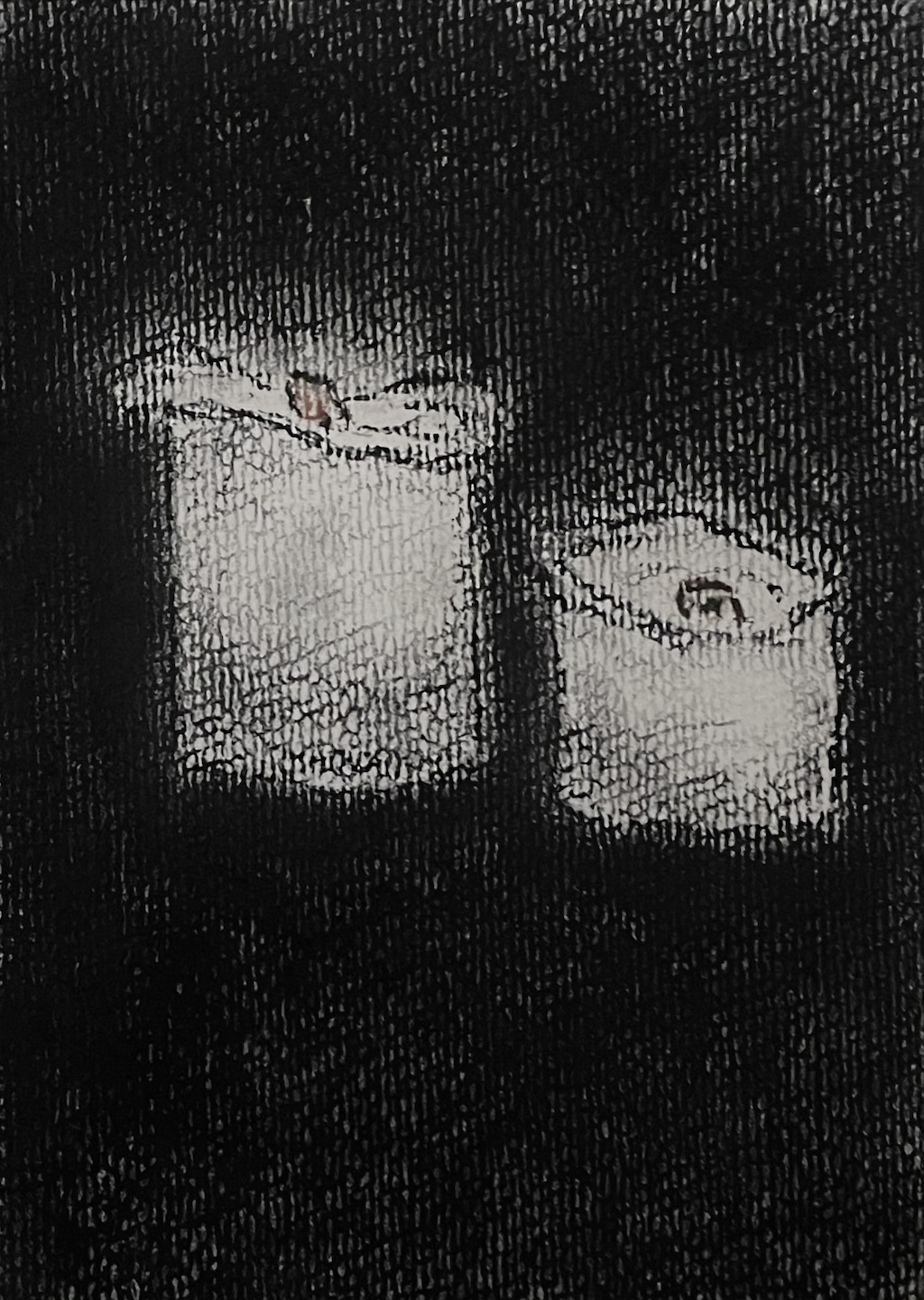 two candles with a small dull glow