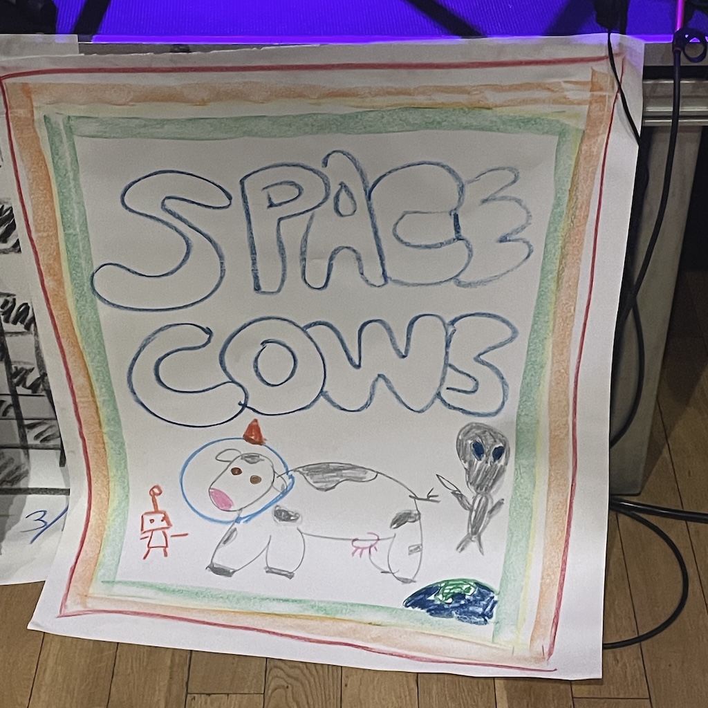 a homemade gig poster of a cow in space