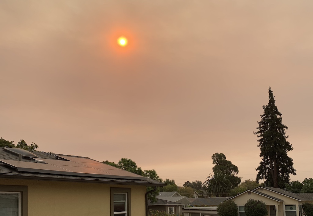 red skies over a neighborhood during california fires